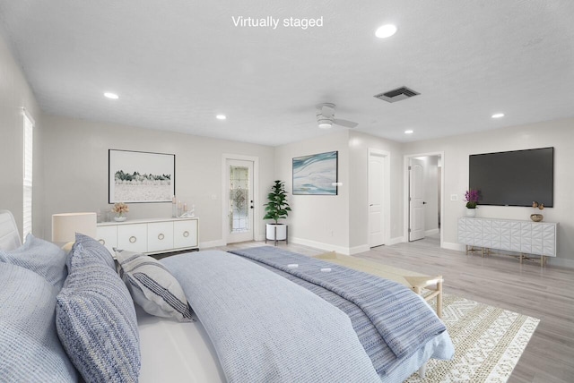 bedroom with access to exterior, visible vents, baseboards, recessed lighting, and light wood-style flooring