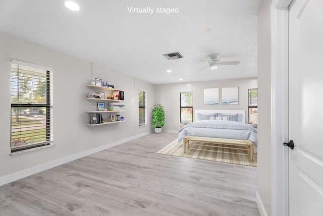 unfurnished bedroom with visible vents, recessed lighting, baseboards, and wood finished floors