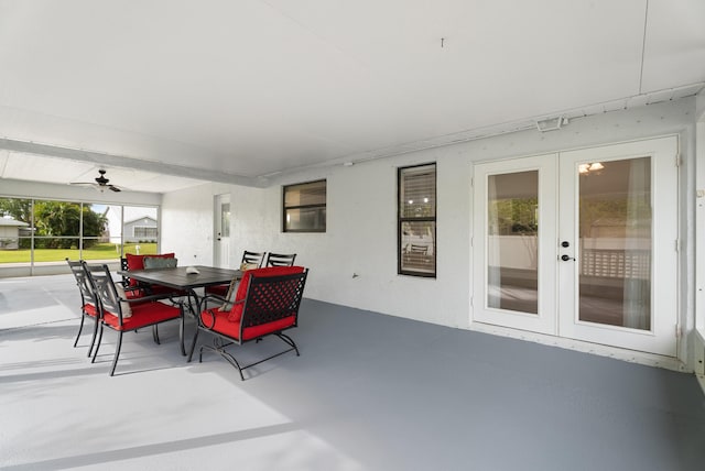 exterior space with french doors, concrete flooring, ceiling fan, and a sunroom