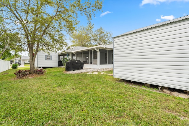 361 SW Carter Ave, Port Saint Lucie, FL 34983 - back of house with a sunroom and a yard