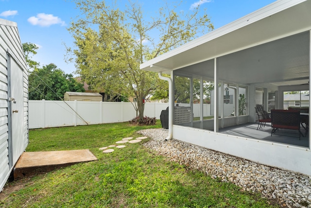 view of yard featuring a patio, a fenced backyard, and a sunroom