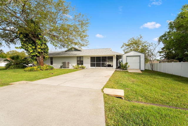 single story home with a front yard, a sunroom, fence, and an outdoor structure