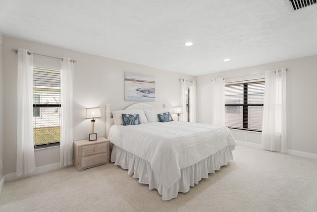 bedroom featuring recessed lighting, visible vents, baseboards, and light colored carpet