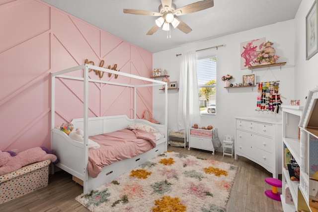 bedroom with ceiling fan and wood finished floors