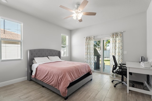 bedroom featuring ceiling fan, light wood-style flooring, baseboards, and access to exterior