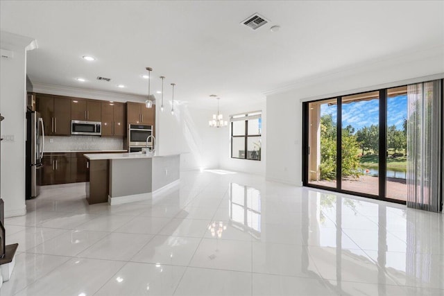 kitchen featuring visible vents, appliances with stainless steel finishes, light countertops, crown molding, and backsplash