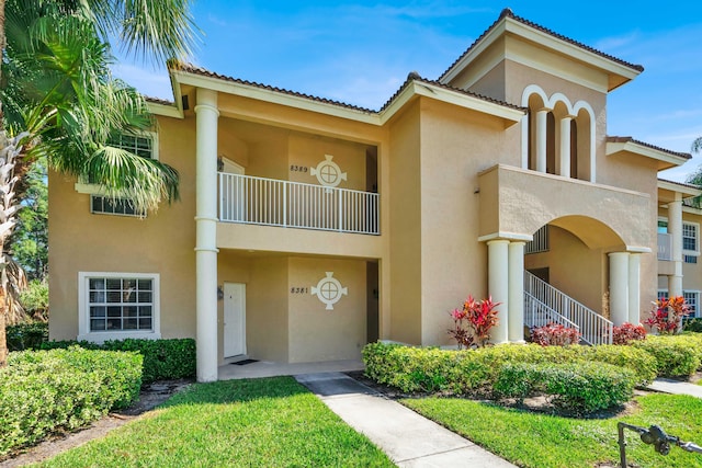 mediterranean / spanish-style home with a tile roof and stucco siding