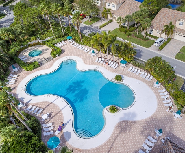 pool with a community hot tub and a patio