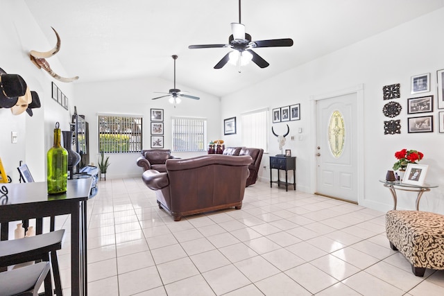 living room with vaulted ceiling, baseboards, and light tile patterned floors