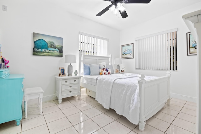 bedroom with light tile patterned floors, ceiling fan, and baseboards