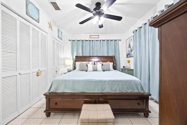 bedroom featuring light tile patterned floors, visible vents, and a ceiling fan