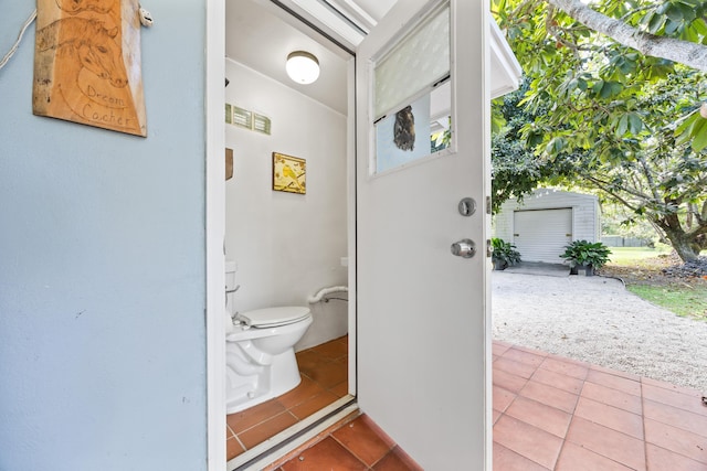 bathroom with toilet and tile patterned flooring