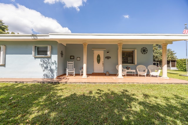 exterior space featuring stucco siding and a yard