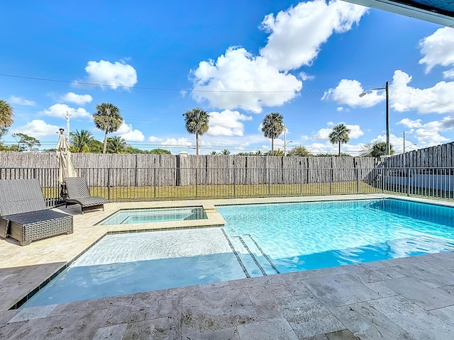 view of swimming pool with a fenced backyard, a pool with connected hot tub, and a patio