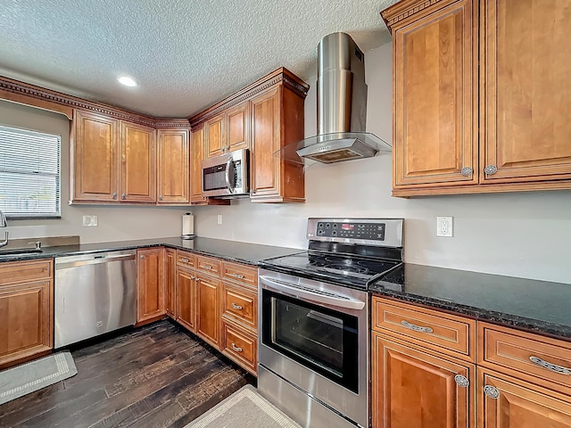 kitchen featuring stainless steel appliances, brown cabinets, wall chimney exhaust hood, and dark wood-style floors