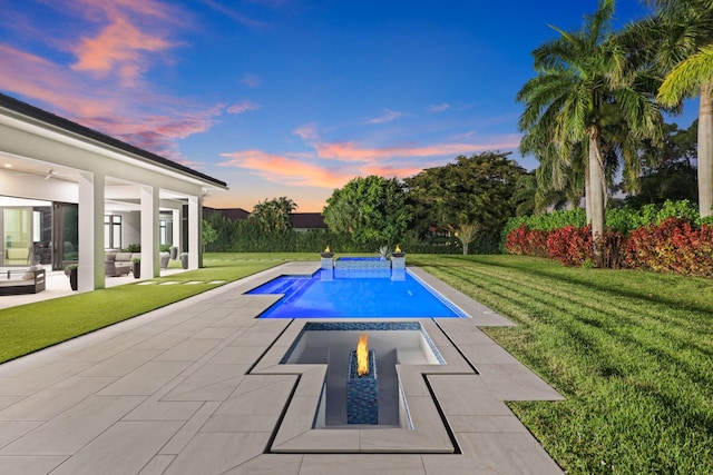 outdoor pool with a patio area, a lawn, and outdoor lounge area