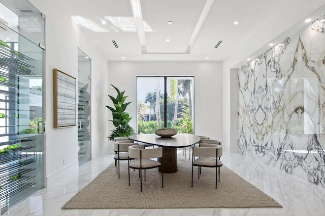 dining area with stone wall, marble finish floor, and recessed lighting