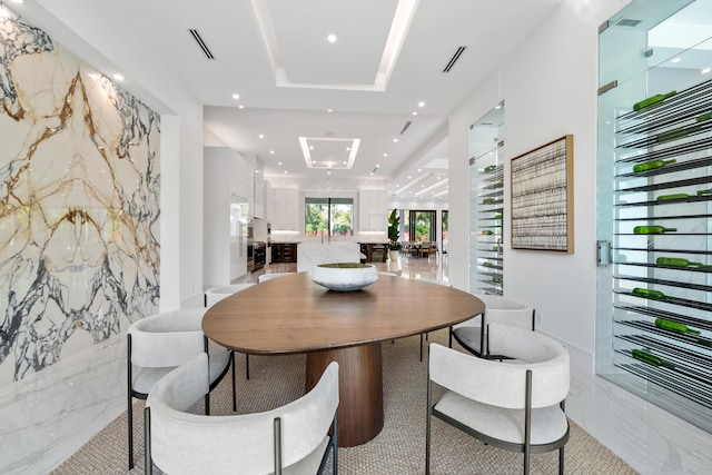 dining space featuring recessed lighting, marble finish floor, visible vents, and stone wall