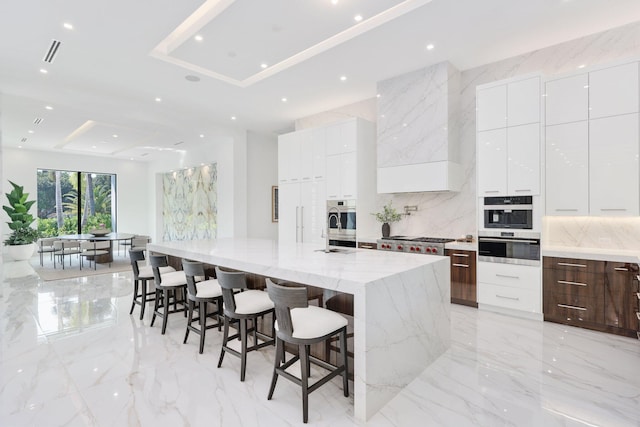 kitchen featuring marble finish floor, modern cabinets, and white cabinets