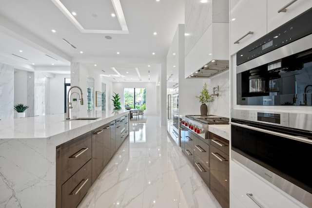 kitchen featuring a sink, white cabinetry, marble finish floor, appliances with stainless steel finishes, and modern cabinets