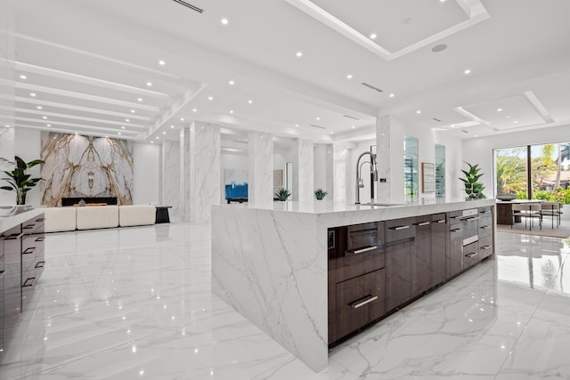 bathroom with stone wall, recessed lighting, marble finish floor, and vanity