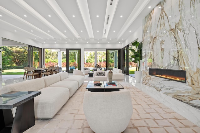 living area featuring a fireplace, beam ceiling, and recessed lighting