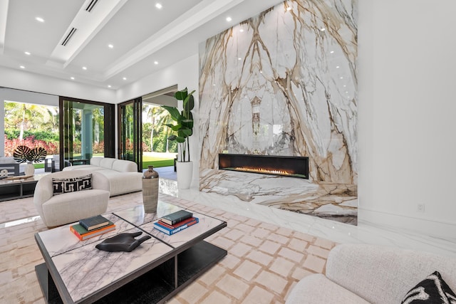 living area with a high end fireplace, recessed lighting, and visible vents