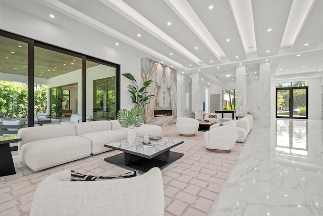 living area featuring recessed lighting, marble finish floor, beamed ceiling, and a premium fireplace