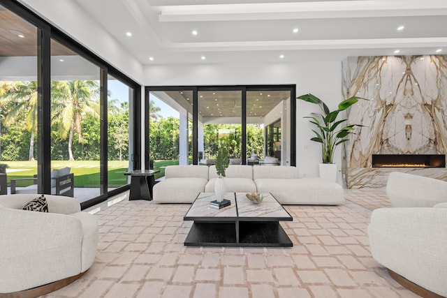 living area with plenty of natural light, a high end fireplace, and recessed lighting