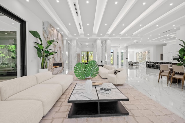 living room featuring marble finish floor, a premium fireplace, and recessed lighting