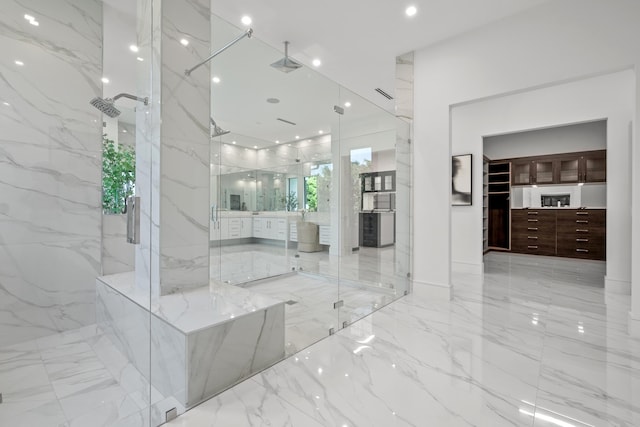 full bath featuring marble finish floor, stone wall, a marble finish shower, and recessed lighting