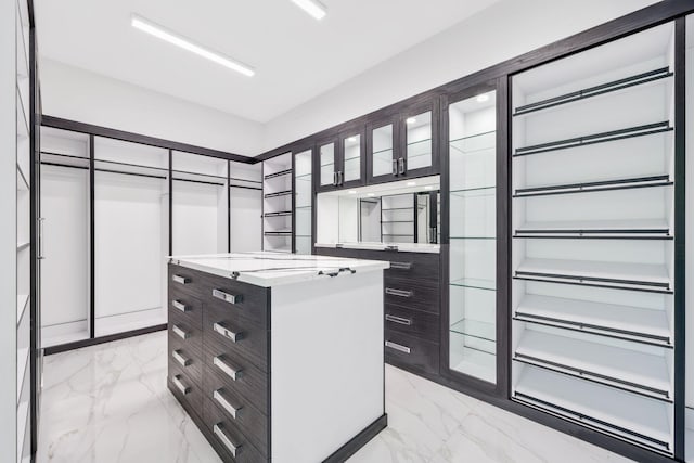 walk in closet with marble finish floor