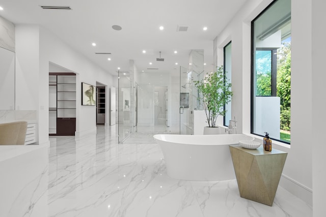 full bathroom with a freestanding tub, recessed lighting, visible vents, marble finish floor, and a stall shower