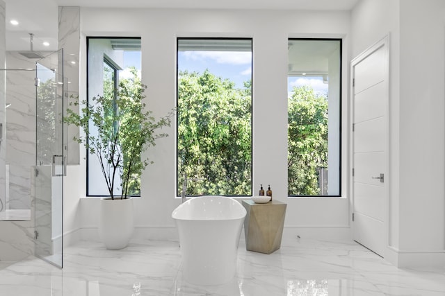 full bath featuring marble finish floor, a marble finish shower, recessed lighting, a freestanding tub, and baseboards