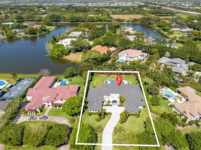 drone / aerial view with a water view and a residential view