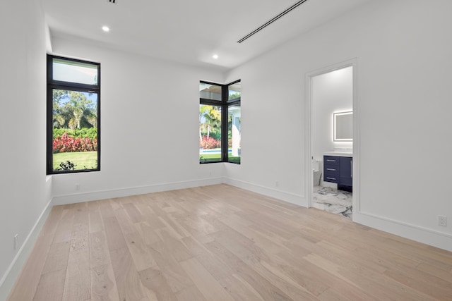 unfurnished room featuring light wood-type flooring, baseboards, and recessed lighting