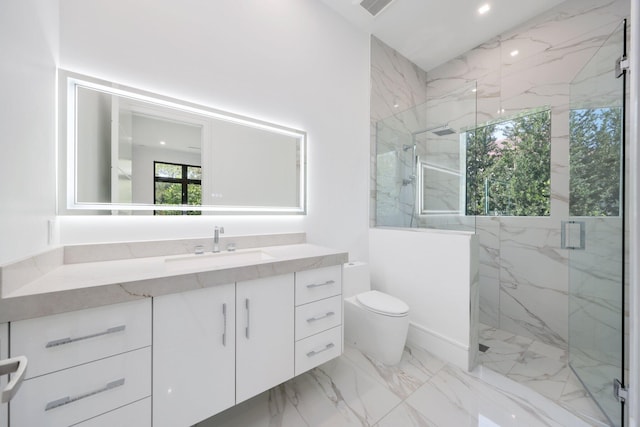 bathroom featuring a marble finish shower, visible vents, toilet, marble finish floor, and vanity