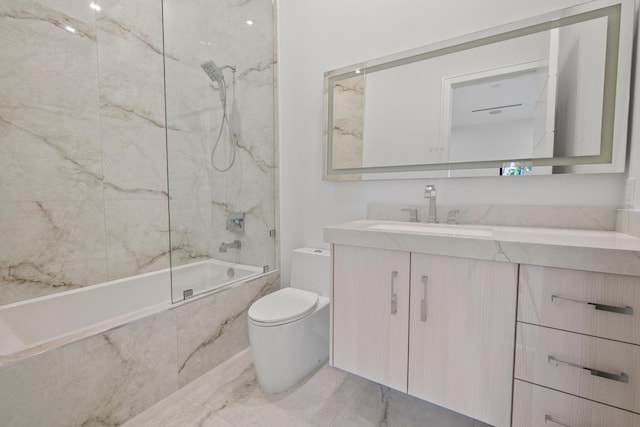 full bath with a combined bath / shower with marble appearance, vanity, toilet, and marble finish floor