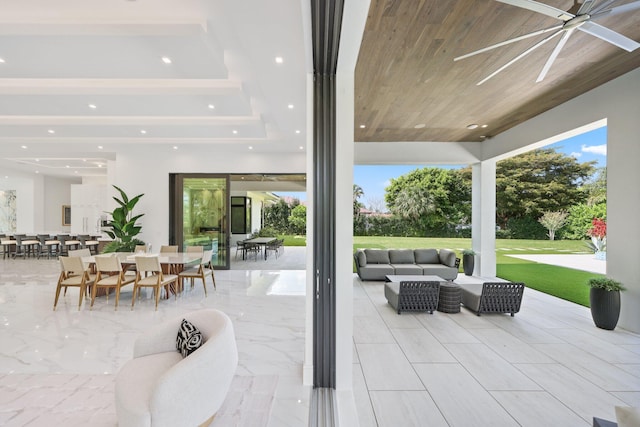 view of patio / terrace featuring outdoor dining area, outdoor lounge area, and a ceiling fan