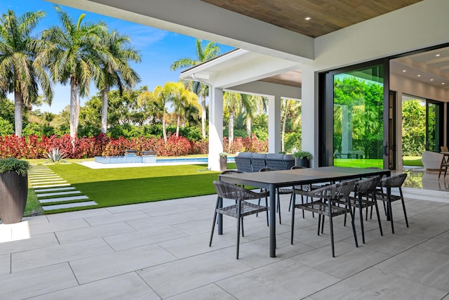 view of patio featuring outdoor dining area and a fenced in pool