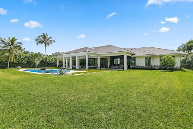 back of house featuring a patio area, an outdoor pool, and a yard