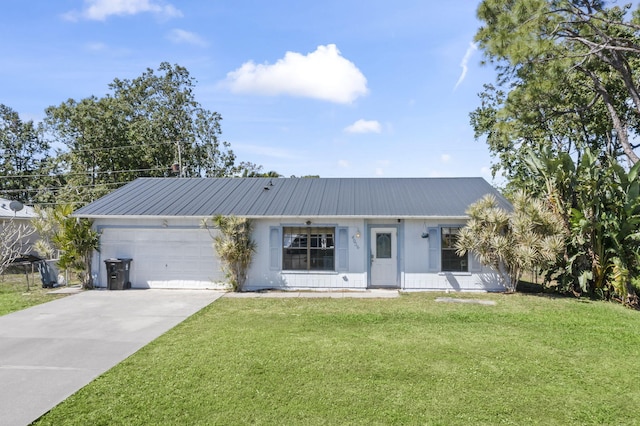 view of front of property featuring an attached garage, metal roof, driveway, and a front yard