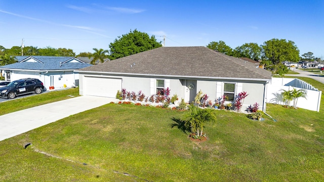 ranch-style home with an attached garage, driveway, and a front yard