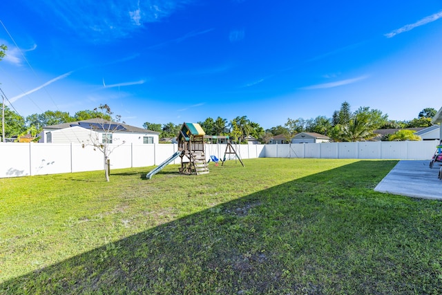 view of yard with a playground and a fenced backyard