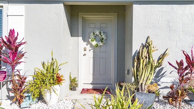 entrance to property with stucco siding