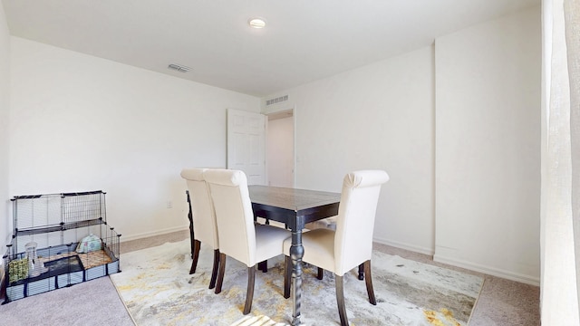 dining area with carpet floors, baseboards, and visible vents