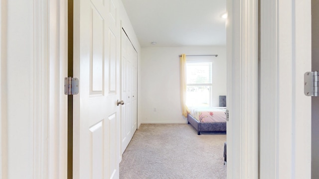 carpeted bedroom featuring baseboards