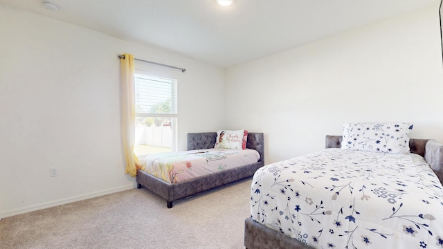 bedroom with carpet flooring and baseboards