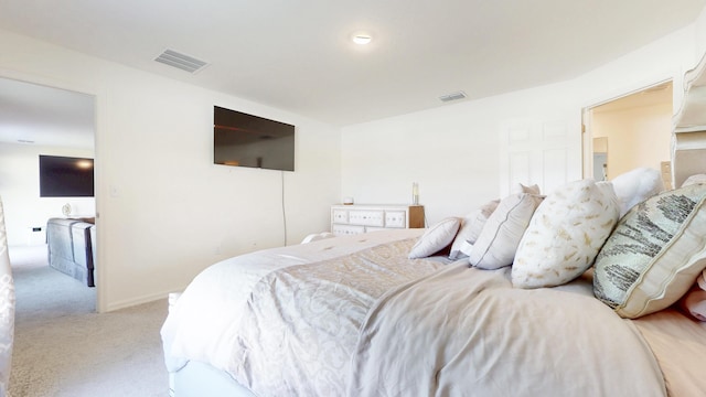 bedroom with visible vents, light carpet, and baseboards