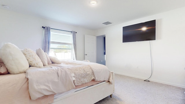 bedroom featuring baseboards, visible vents, and carpet flooring